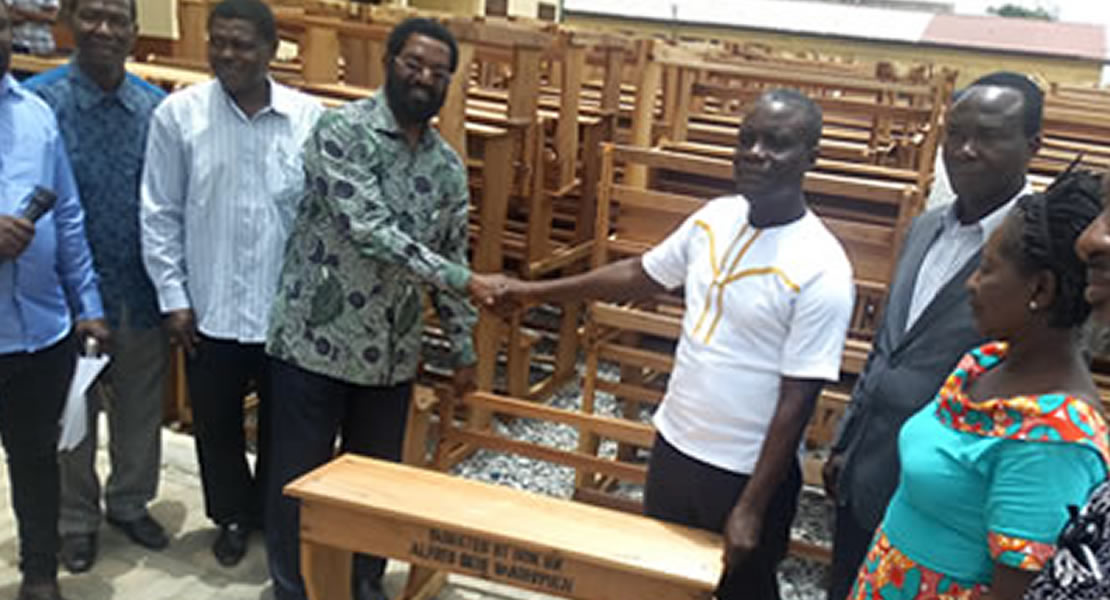 Okoe Vanderpuije presents desks to schools